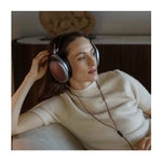 Lifestyle with person listening to Meze POET audiophile headphones